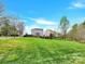 Scenic view of neighborhood homes across a large green lawn, with lush landscaping at 12424 Bradford Park Dr, Davidson, NC 28036