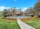 View of a fenced community pool and recreation area with a picnic pavilion and playground at 12424 Bradford Park Dr, Davidson, NC 28036