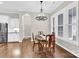 A formal dining room features hardwood floors, a chandelier and large windows providing natural light at 12424 Bradford Park Dr, Davidson, NC 28036