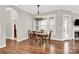 A spacious dining room is enhanced with hardwood floors, a modern chandelier and an abundance of natural light at 12424 Bradford Park Dr, Davidson, NC 28036