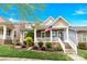 Inviting two-story home showcasing a delightful front porch, picturesque landscaping, and an American flag at 12424 Bradford Park Dr, Davidson, NC 28036