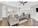 Comfortable living room featuring hardwood floors, neutral tones, and a seamless transition to the kitchen at 12424 Bradford Park Dr, Davidson, NC 28036