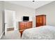 Bright main bedroom featuring light gray walls, and an open en suite bathroom at 12424 Bradford Park Dr, Davidson, NC 28036