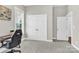 A practical home office features double doors, a window for natural light, and is equipped with a modern desk setup at 12424 Bradford Park Dr, Davidson, NC 28036