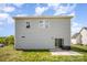 Backyard view of two-story home with gray siding, patio, and a well-maintained lawn at 1436 Yellowstone Ct, Gastonia, NC 28054
