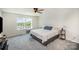 Carpeted bedroom with a queen size bed, ceiling fan, and large windows for natural light at 1436 Yellowstone Ct, Gastonia, NC 28054