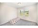 Bright bedroom with gray carpet and a window at 1436 Yellowstone Ct, Gastonia, NC 28054