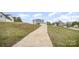 Exterior of a gray home, front facing, as seen from the bottom of a long driveway at 1436 Yellowstone Ct, Gastonia, NC 28054