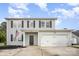 Two-story home with gray siding, black shutters, an American flag, and a two-car garage at 1436 Yellowstone Ct, Gastonia, NC 28054