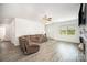 Living room with hardwood floors, a ceiling fan, and neutral paint colors at 1436 Yellowstone Ct, Gastonia, NC 28054