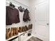 Mud room with white shoe racks, coat hooks, and door to the garage at 1436 Yellowstone Ct, Gastonia, NC 28054