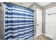 Bathroom featuring a blue and white striped shower curtain and a neutral color scheme at 147 Gabriel Dr, Mooresville, NC 28115