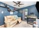 Cozy bedroom with a comfortable recliner sofa, playful decorations, and a modern ceiling fan at 147 Gabriel Dr, Mooresville, NC 28115