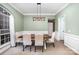 Well-lit dining area featuring a rustic table set, white walls, and a large window at 147 Gabriel Dr, Mooresville, NC 28115