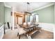 Elegant dining room with a rustic wooden table, chairs, and a bench under decorative chandelier at 147 Gabriel Dr, Mooresville, NC 28115
