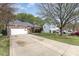 View of the front exterior including a basketball hoop, two car garage, and additional parking at 147 Gabriel Dr, Mooresville, NC 28115