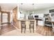 Open kitchen with white cabinets, stainless steel appliances, and a breakfast bar at 147 Gabriel Dr, Mooresville, NC 28115
