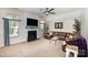 Bright living room with fireplace, large TV, neutral colors, and comfortable seating at 147 Gabriel Dr, Mooresville, NC 28115