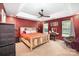 Spacious main bedroom features a tray ceiling, modern fan, and a rustic wood bed frame at 147 Gabriel Dr, Mooresville, NC 28115