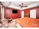 Spacious main bedroom featuring a mounted TV, tray ceiling, and a comfortable seating area at 147 Gabriel Dr, Mooresville, NC 28115