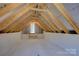 Unfinished attic space with exposed rafters offering potential for storage or customization in this home at 14916 Creeks Edge Dr, Charlotte, NC 28278