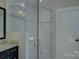 Bathroom shower enclosed in seamless glass, with neutral tiling and a built-in niche at 14916 Creeks Edge Dr, Charlotte, NC 28278
