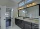 Bathroom vanity featuring a double sink, granite countertop, and neutral tiling at 14916 Creeks Edge Dr, Charlotte, NC 28278