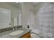 Bathroom features a granite countertop, framed mirror, and tub-shower combo at 14916 Creeks Edge Dr, Charlotte, NC 28278