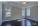 Bright bedroom with hardwood floors and large windows that allow natural light to illuminate the room at 14916 Creeks Edge Dr, Charlotte, NC 28278