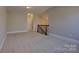 Upstairs bonus room featuring neutral carpet, light walls, and decorative railing at 14916 Creeks Edge Dr, Charlotte, NC 28278