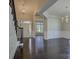 Elegant foyer featuring dark hardwood floors, a grand staircase, and a decorative chandelier at 14916 Creeks Edge Dr, Charlotte, NC 28278