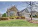 Charming brick home with a two-car garage, manicured lawn, and mature landscaping at 14916 Creeks Edge Dr, Charlotte, NC 28278