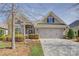 Attractive home with brick and stone accents, a two-car garage, and manicured landscaping at 14916 Creeks Edge Dr, Charlotte, NC 28278
