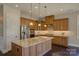 Kitchen with stainless steel appliances, granite countertops, hardwood floors, and custom cabinets at 14916 Creeks Edge Dr, Charlotte, NC 28278