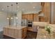 Kitchen featuring an island with granite countertops, stainless steel appliances, custom cabinets, and hardwood floors at 14916 Creeks Edge Dr, Charlotte, NC 28278