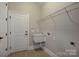 Functional laundry room with utility sink and ample shelving for storage at 14916 Creeks Edge Dr, Charlotte, NC 28278