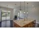 Open concept living room with fireplace, hardwood floors, and sliding glass doors at 14916 Creeks Edge Dr, Charlotte, NC 28278