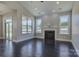 Bright living room featuring a fireplace, hardwood floors, and large windows with outdoor views at 14916 Creeks Edge Dr, Charlotte, NC 28278