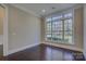 Room with dark hardwood floors, neutral walls, and natural light from a large window at 14916 Creeks Edge Dr, Charlotte, NC 28278
