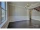 Formal dining room with a chandelier, wainscoting, and dark hardwood floors at 14916 Creeks Edge Dr, Charlotte, NC 28278