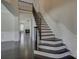 Elegant staircase with iron railings and dark wood floors open to living space at 14916 Creeks Edge Dr, Charlotte, NC 28278