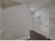 Spacious walk-in closet featuring custom shelving and dark hardwood floors at 14916 Creeks Edge Dr, Charlotte, NC 28278