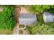 An aerial view showcasing the roof, driveway, and surrounding green landscaping at 1519 Briarfield Dr, Charlotte, NC 28205