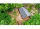 An aerial view showcasing the house, the roof, patio and surrounding green landscaping at 1519 Briarfield Dr, Charlotte, NC 28205
