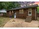 This backyard features a brick patio and an external door to the home at 1519 Briarfield Dr, Charlotte, NC 28205