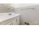 Bathroom featuring a white vanity with storage, and light grey wall tiles at 1519 Briarfield Dr, Charlotte, NC 28205