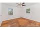 A spacious bedroom with hardwood flooring and two windows letting in natural light at 1519 Briarfield Dr, Charlotte, NC 28205