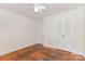 A bedroom featuring hardwood floors, a ceiling fan, and double-door closet at 1519 Briarfield Dr, Charlotte, NC 28205