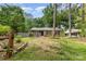 Charming single-story brick home with a cozy front porch and a lush green lawn at 1519 Briarfield Dr, Charlotte, NC 28205