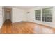 Inviting living area featuring hardwood floors, neutral walls, and abundant natural light from the large windows at 1519 Briarfield Dr, Charlotte, NC 28205